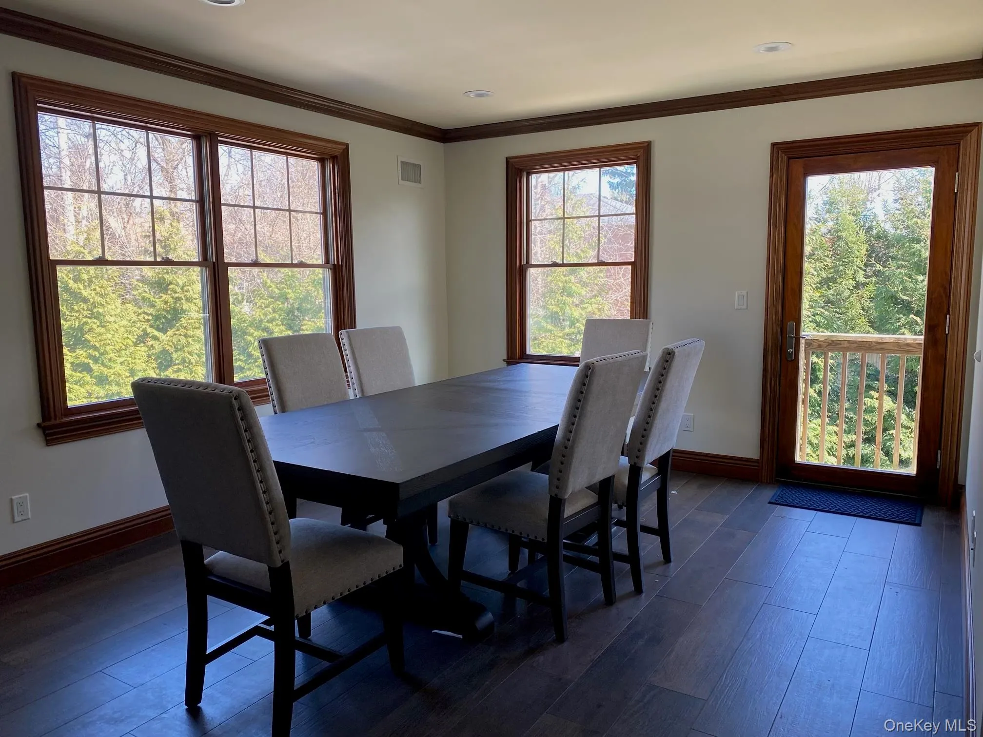 Dining area featuring rich wood-finish flooring, recessed lighting, and crown molding Dining area featuring rich wood-finish flooring, recessed lighting, and crown molding