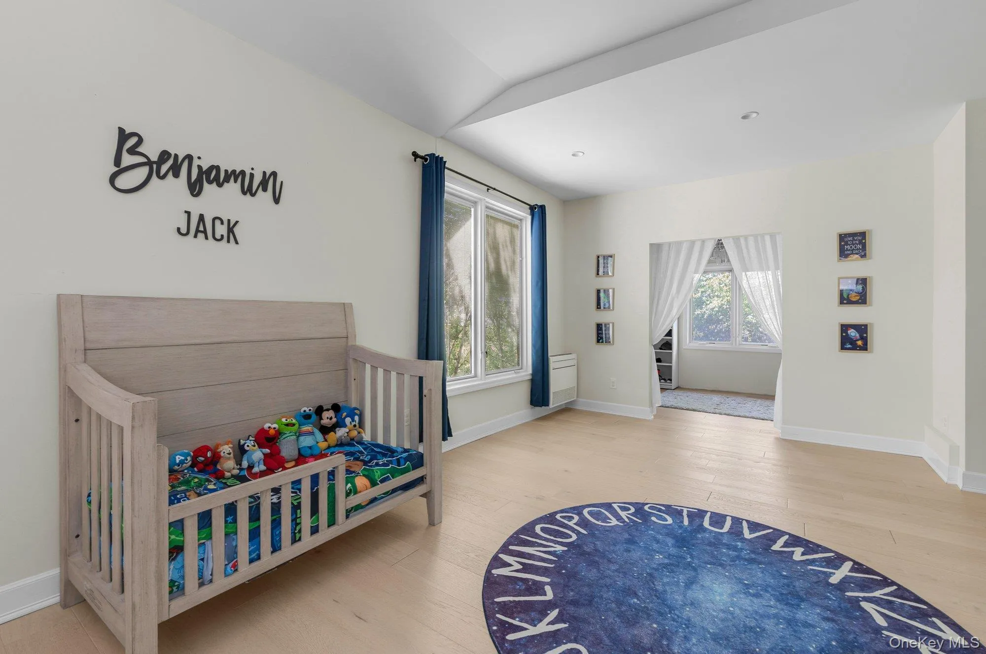Light-filled interior space featuring wood-finish flooring and white baseboards Light-filled interior space featuring wood-finish flooring and white baseboards
