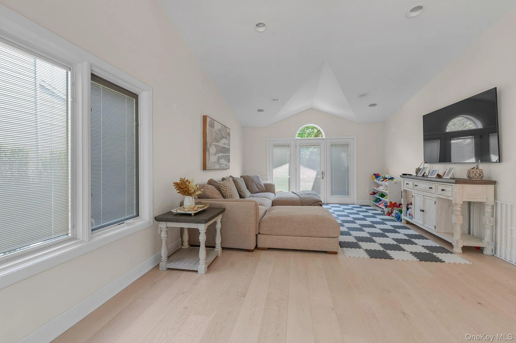 Light-toned wood-finish flooring complements the room's neutral wall tones Light-toned wood-finish flooring complements the room's neutral wall tones