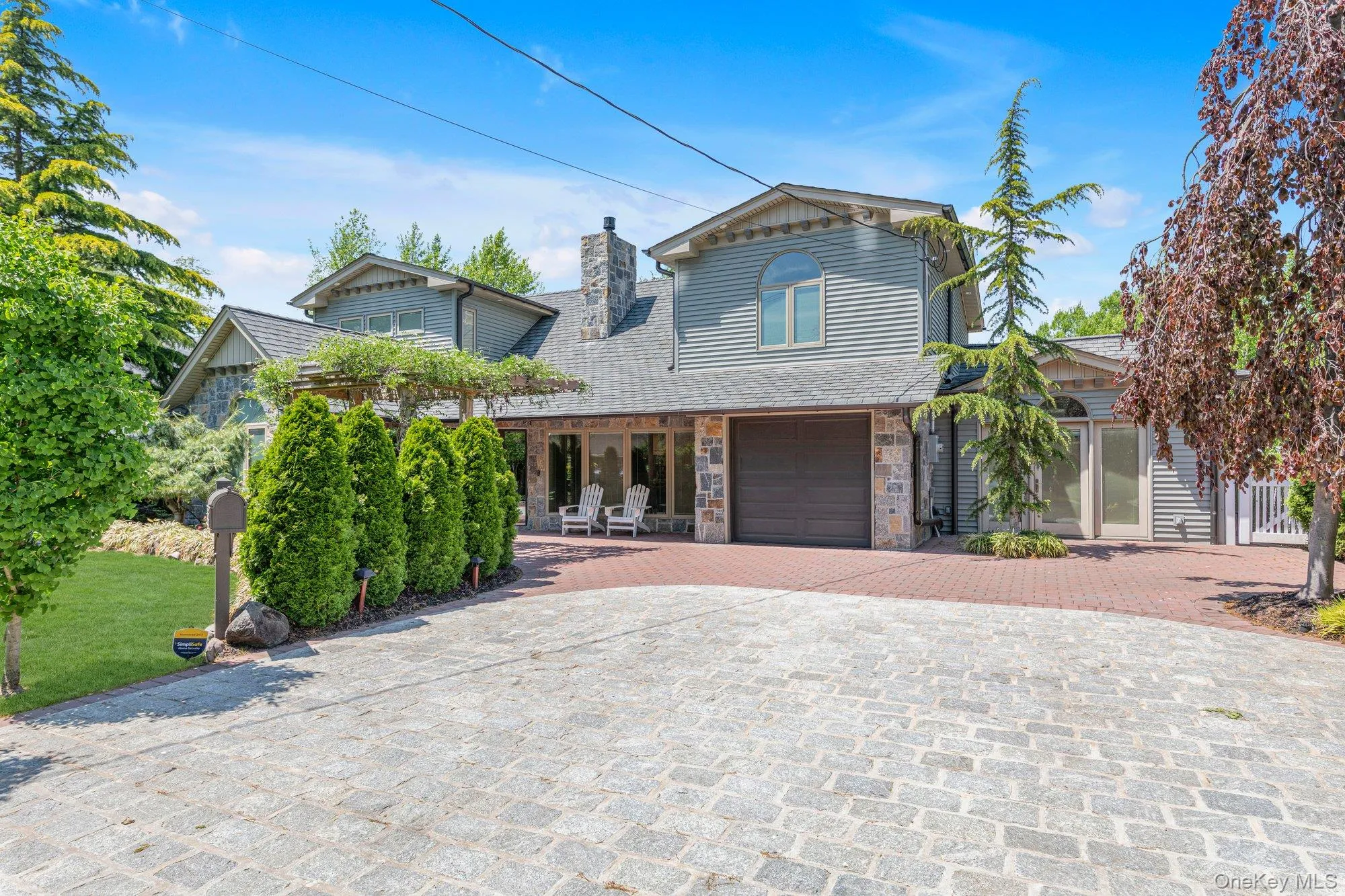 Stone and siding exterior with a multi-level roofline Stone and siding exterior with a multi-level roofline