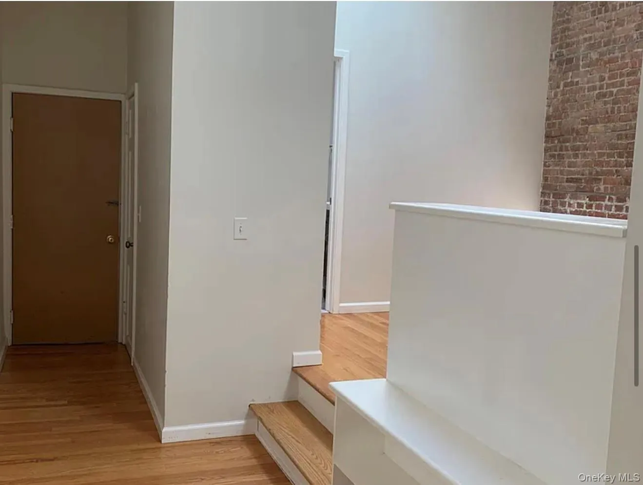 Hallway featuring light wood-style floors and baseboards Hallway featuring light wood-style floors and baseboards