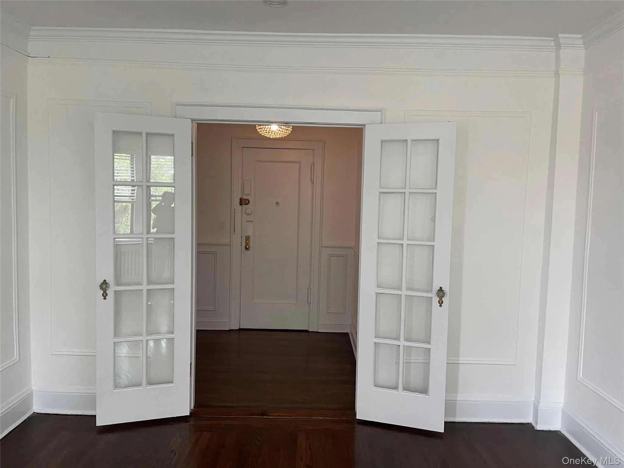 View through French doors out to front hall View through French doors out to front hall