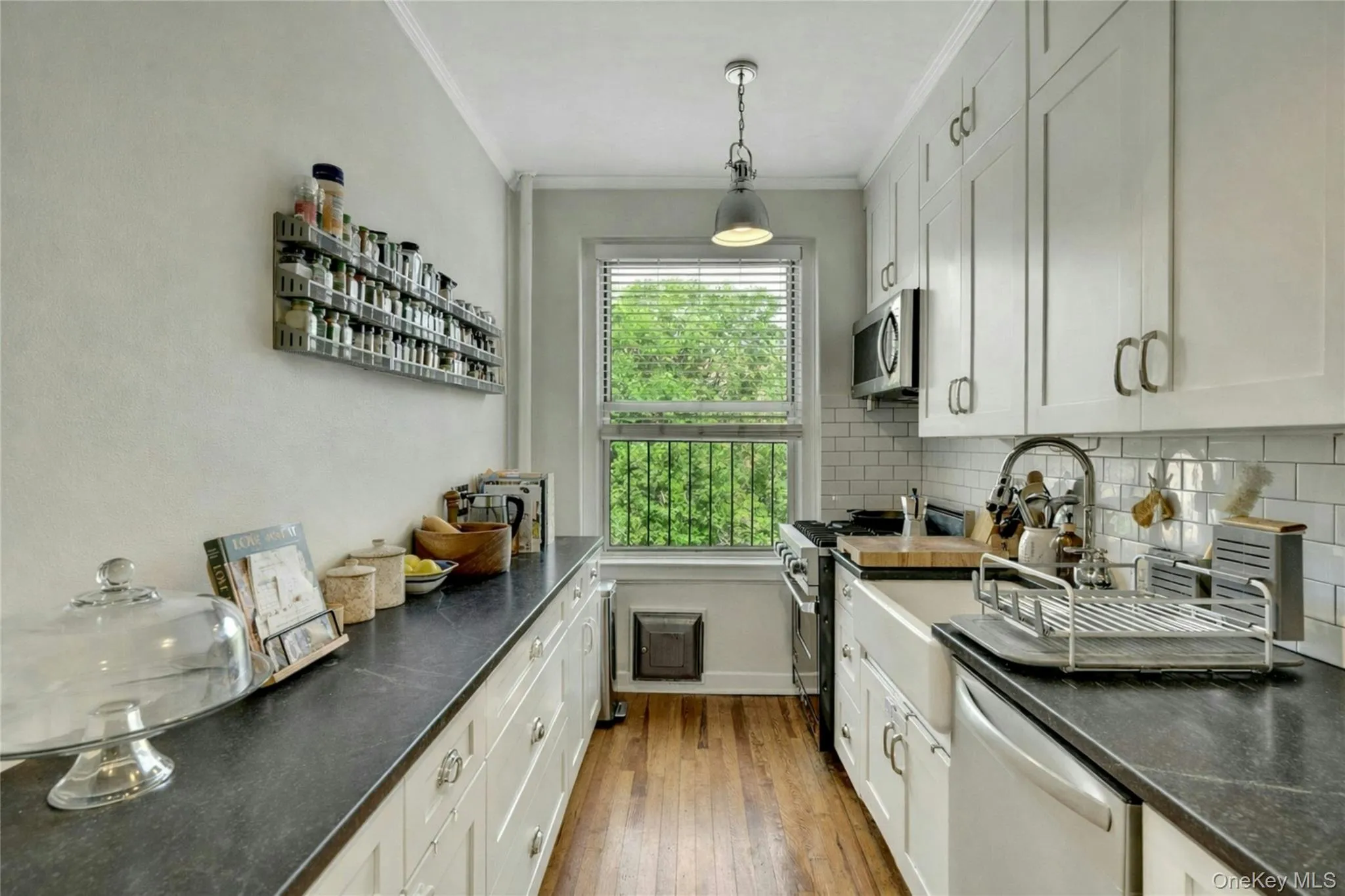 Notice the amount of work space and cabinet storage this well-lit kitchen offers. Notice the amount of work space and cabinet storage this well-lit kitchen offers.