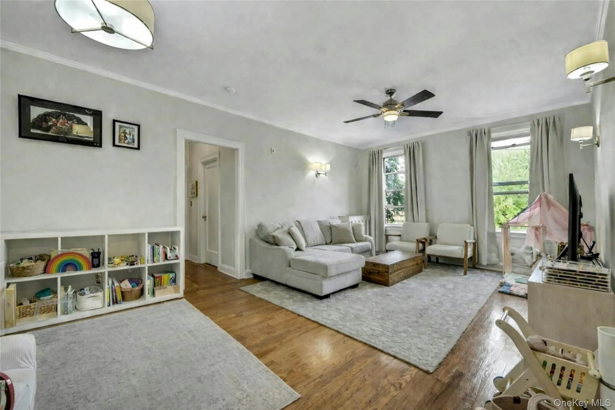 The open living area, with its large windows, crown molding, fresh paint, and beautiful wood floors welcomes you home. The open living area, with its large windows, crown molding, fresh paint, and beautiful wood floors welcomes you home.