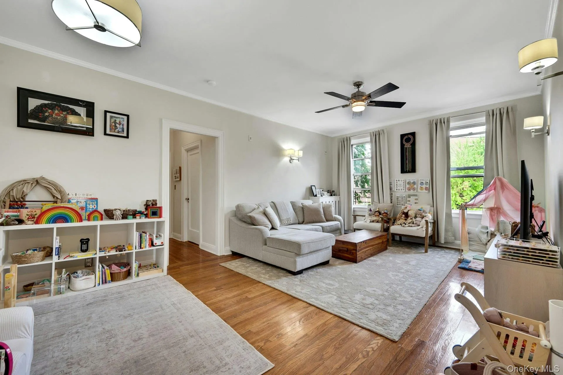 The open living area, with its large windows, crown molding, fresh paint, and beautiful wood floors welcomes you home. The open living area, with its large windows, crown molding, fresh paint, and beautiful wood floors welcomes you home.