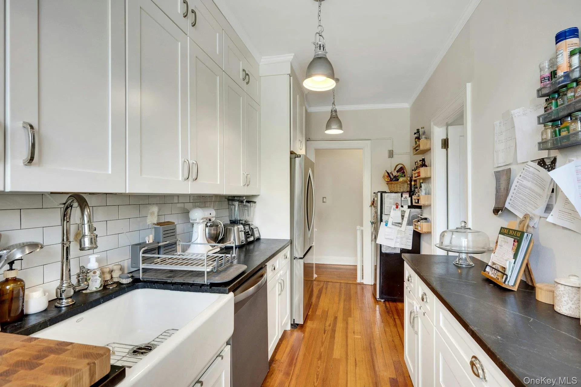 The kitchen has a practical and pretty farm sink and lovely solid wood floors. The dishwasher is new! The kitchen has a practical and pretty farm sink and lovely solid wood floors. The dishwasher is new!