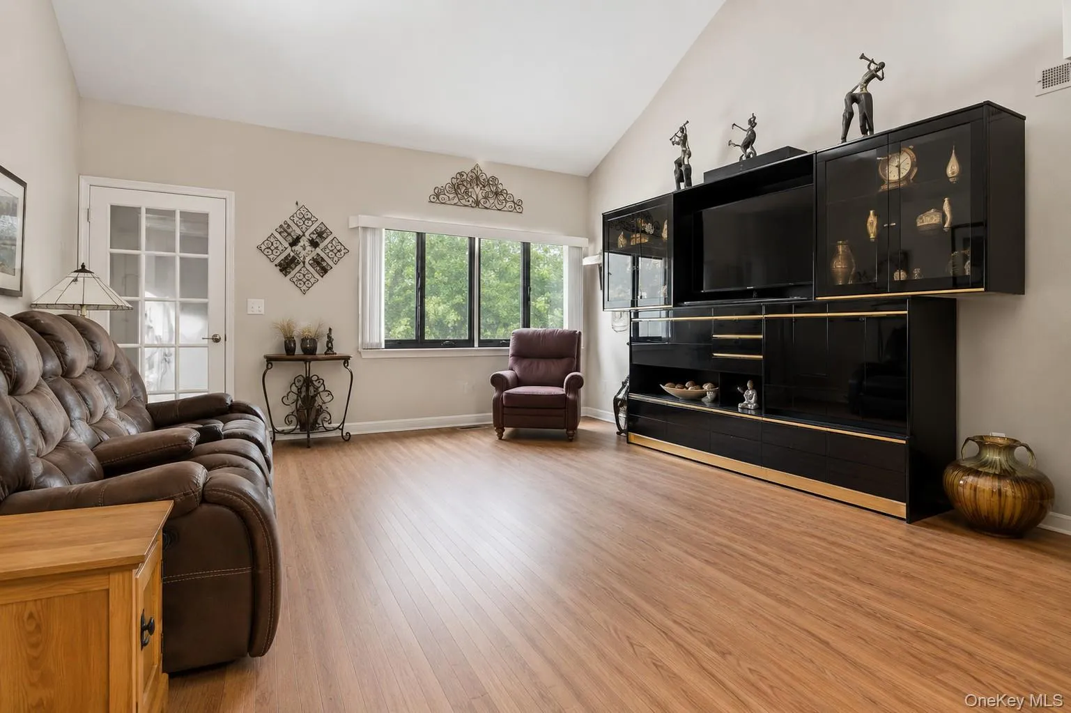 Large open concept living room with vaulted ceiling and wood-burning fireplace Large open concept living room with vaulted ceiling and wood-burning fireplace