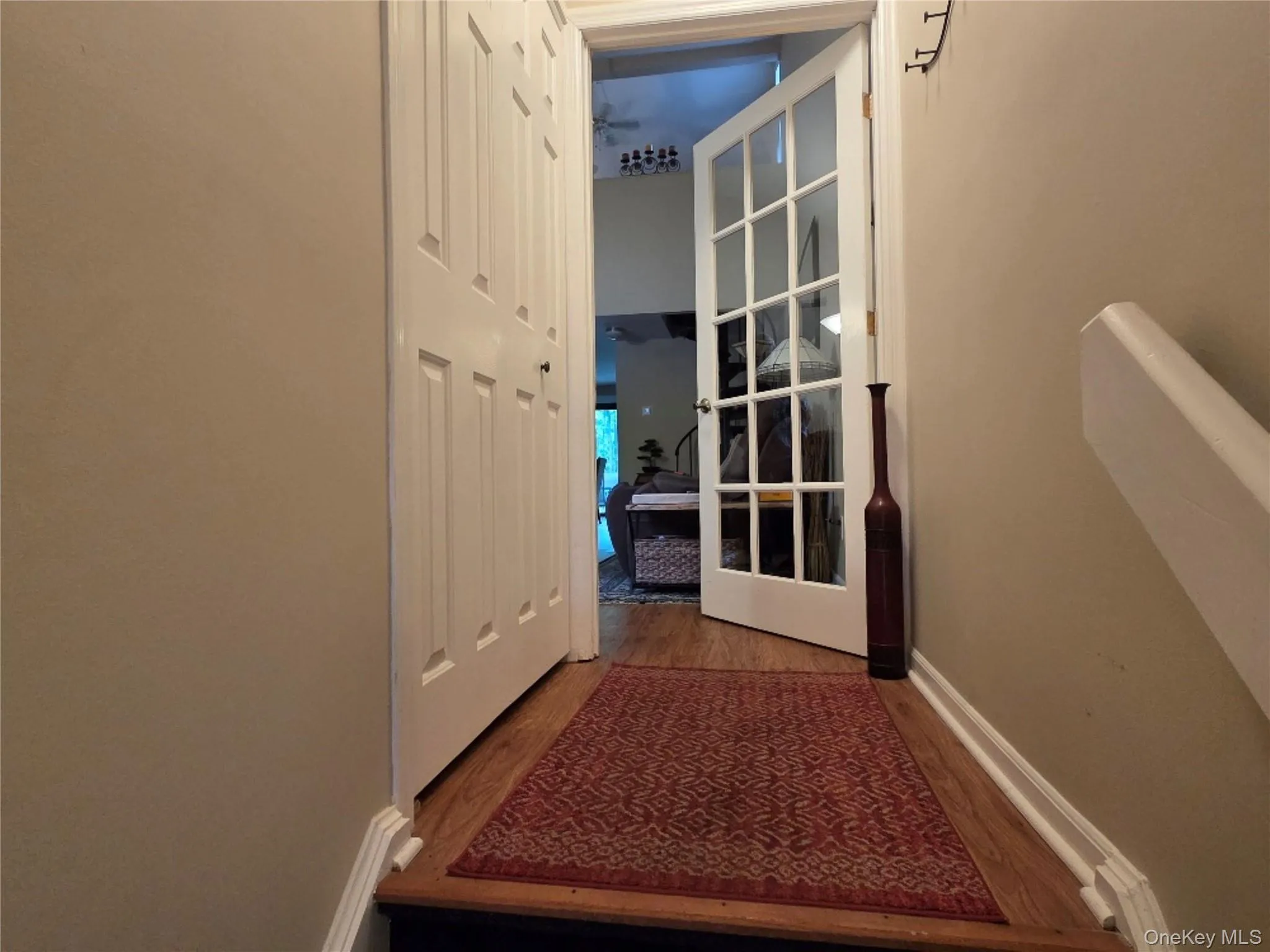 Foyer including a generous coat closet, wood finished floors and an interior French door. Foyer including a generous coat closet, wood finished floors and an interior French door.