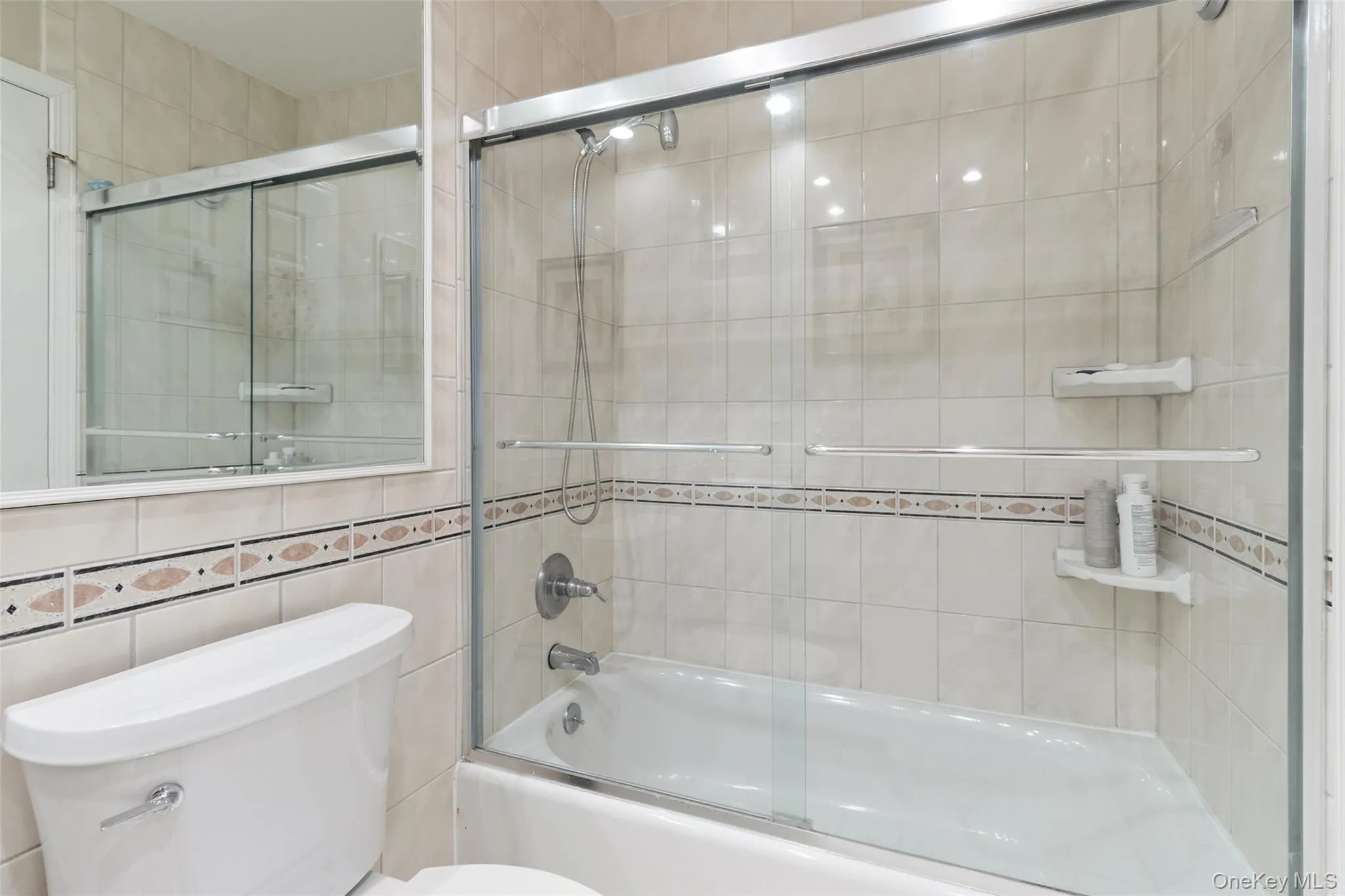 Bathroom with a tub/shower combination, providing a practical and comfortable setup suitable for daily living. Bathroom with a tub/shower combination, providing a practical and comfortable setup suitable for daily living.