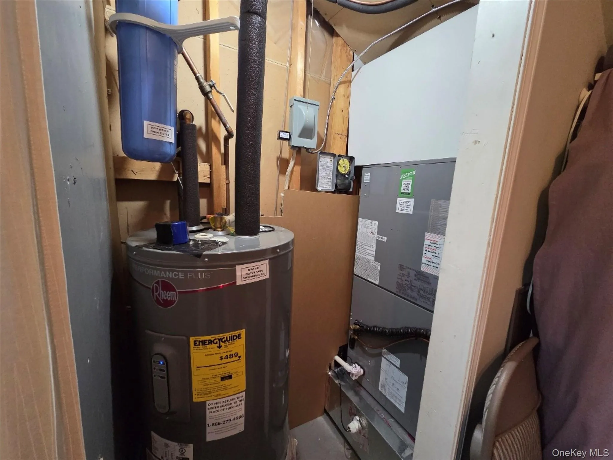 Utility closet featuring a new water heater, water filter, and new HVAC system Utility closet featuring a new water heater, water filter, and new HVAC system