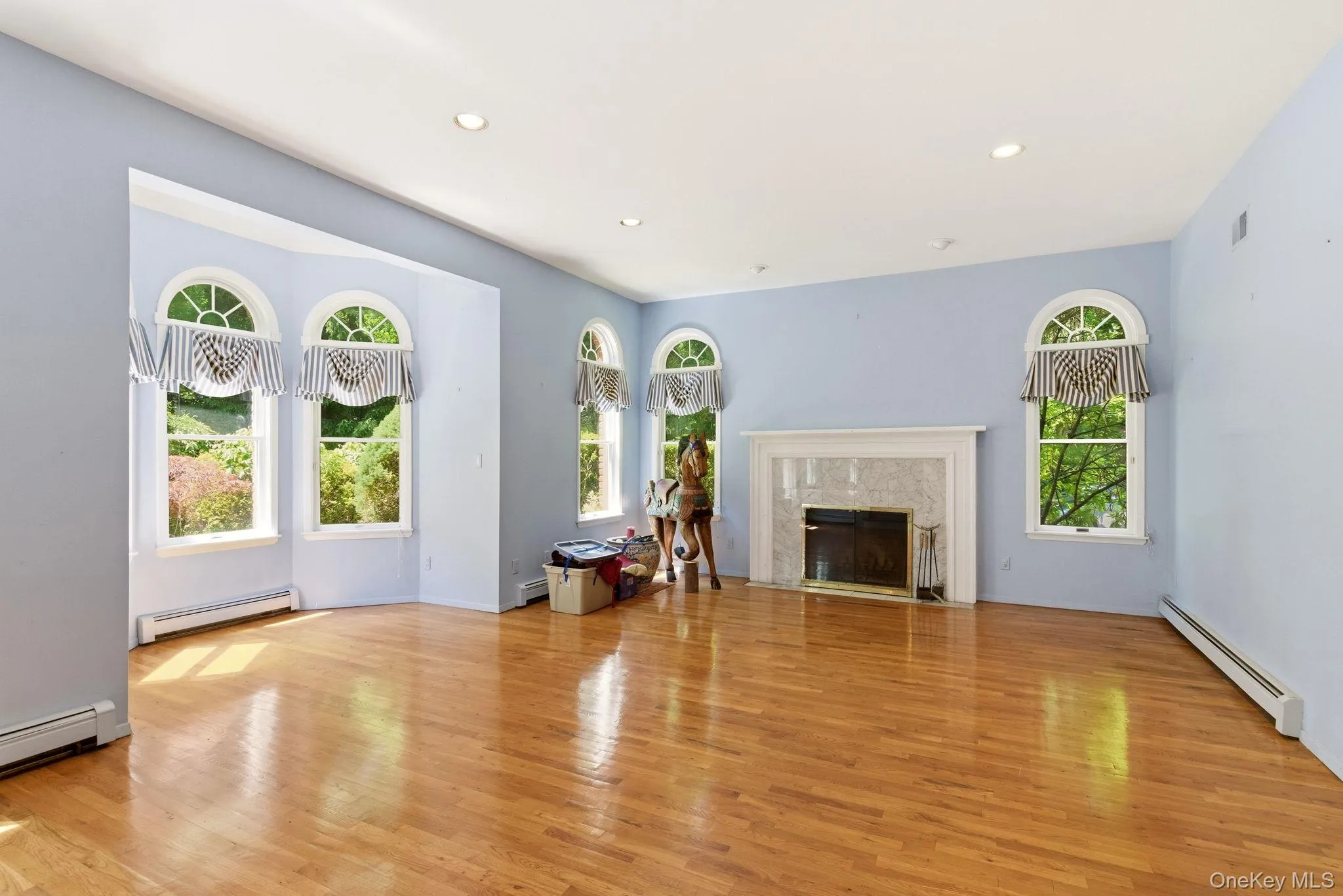 Living room with hardwood floors, high ceilings and fireplace Living room with hardwood floors, high ceilings and fireplace