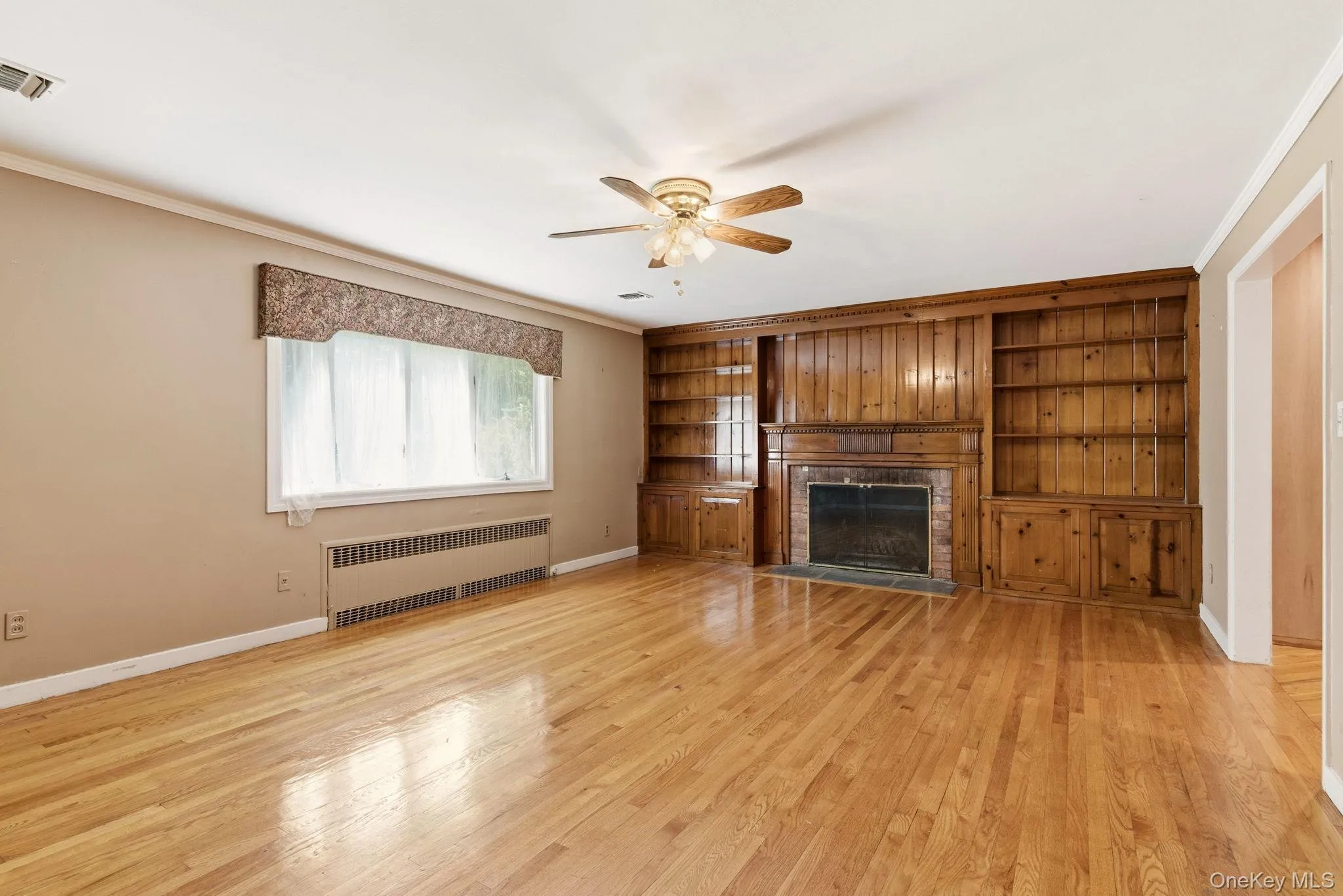 Den with hardwood floors and fireplace Den with hardwood floors and fireplace