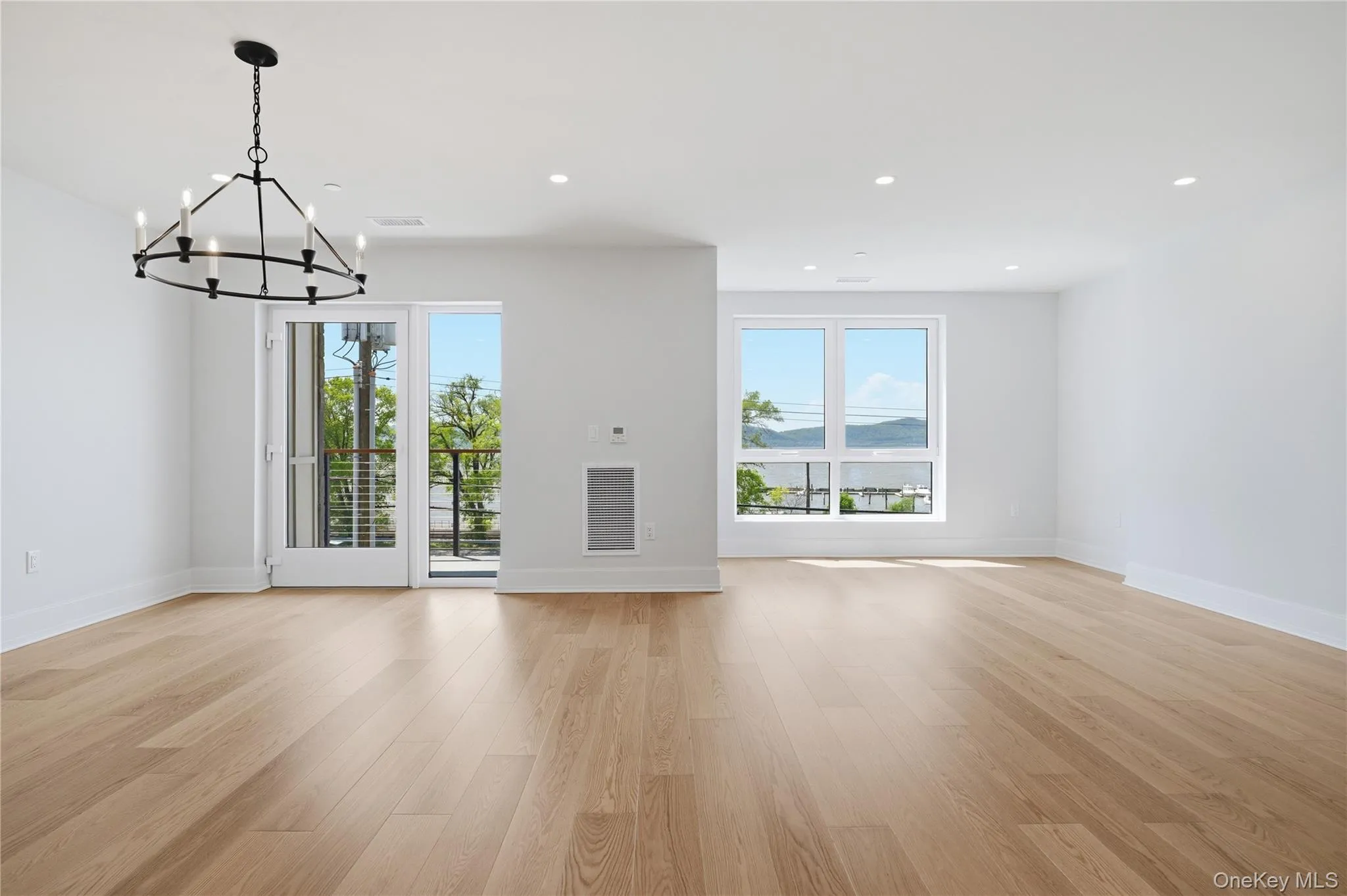 Dining Room and Living Room with balcony and water views Dining Room and Living Room with balcony and water views