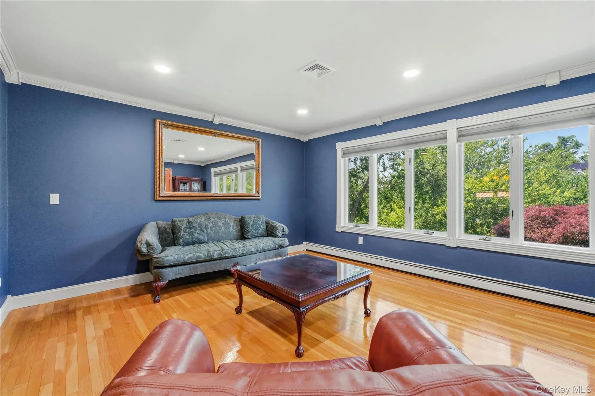 Another angle of living room with a wall of windows. Another angle of living room with a wall of windows.