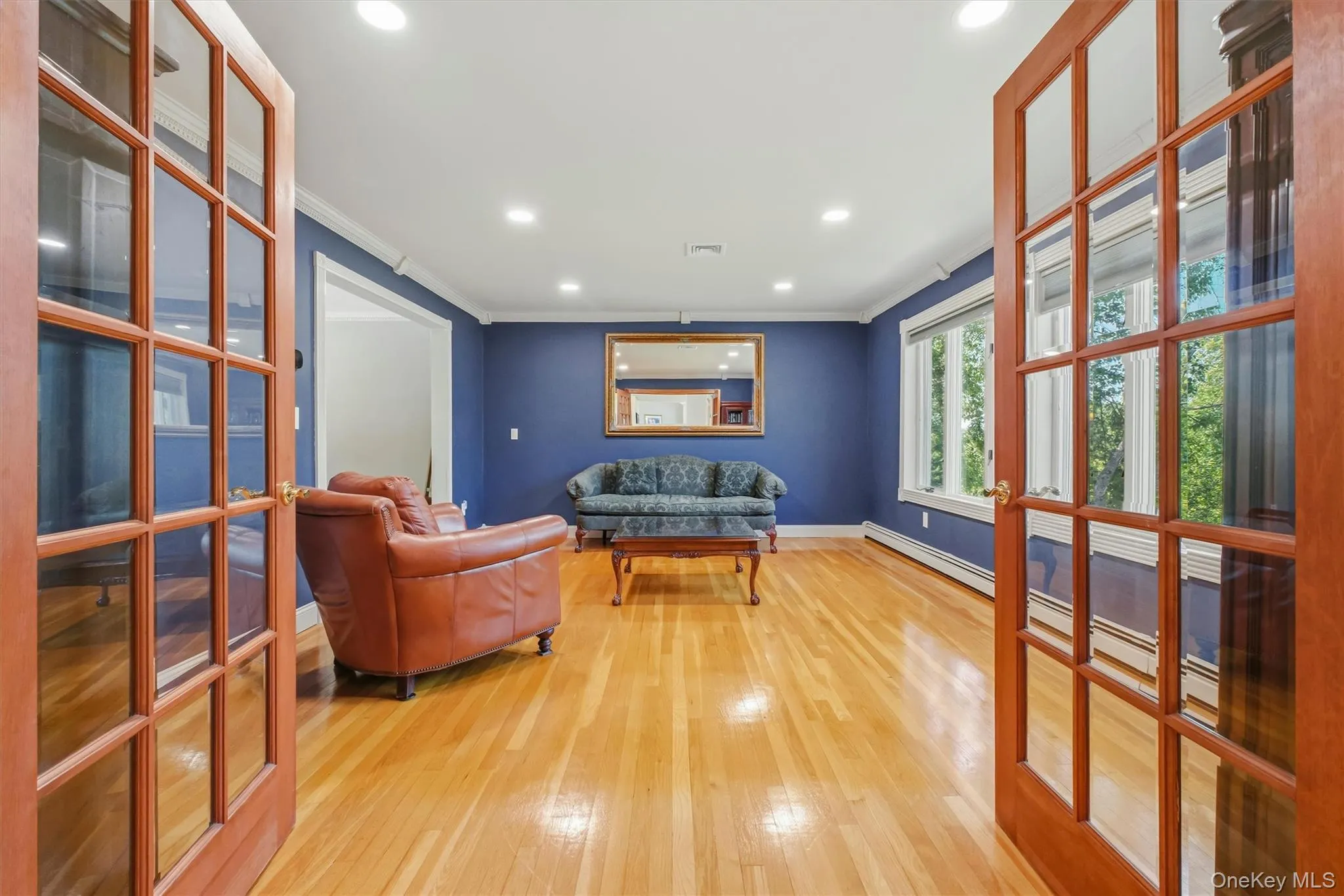 Formal living room with French doors from entrance hall. Formal living room with French doors from entrance hall.