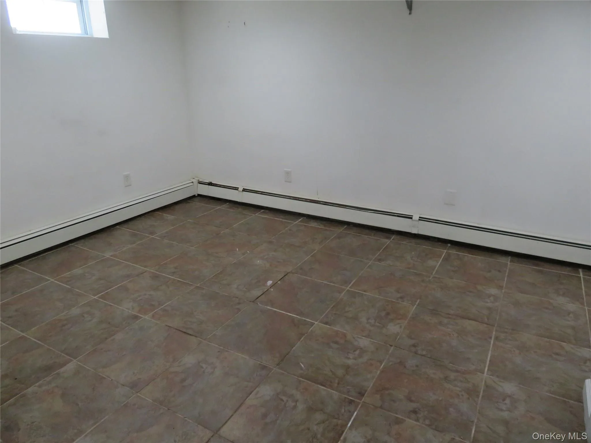 Room featuring neutral wall finishes and a window Room featuring neutral wall finishes and a window