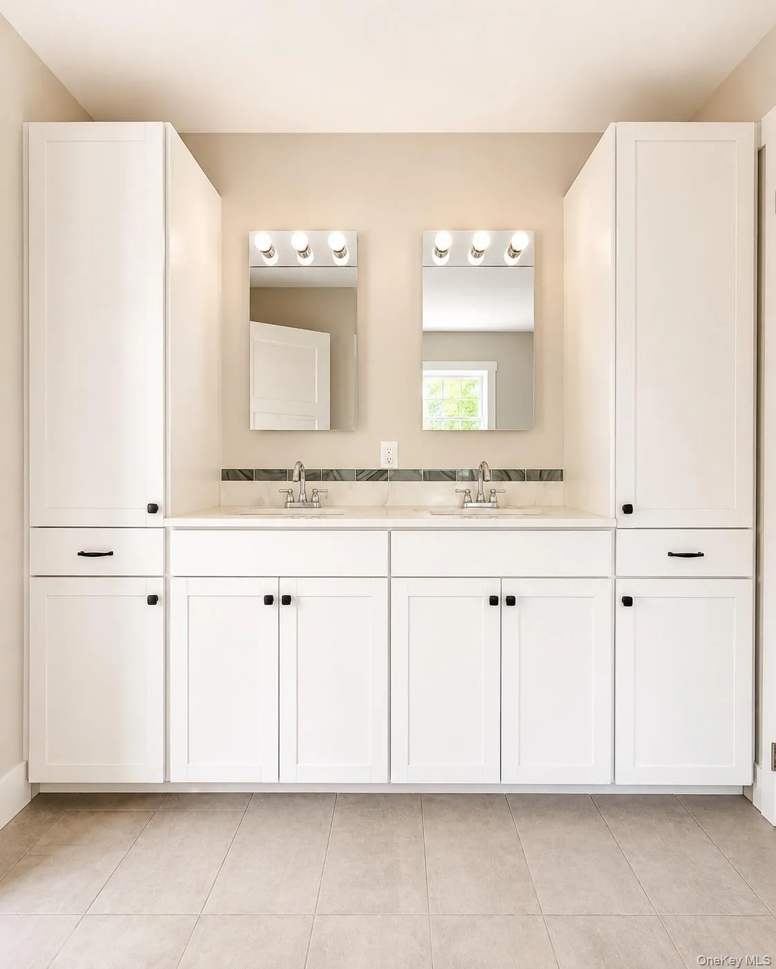 Double vanity with white cabinetry and dark hardware Double vanity with white cabinetry and dark hardware