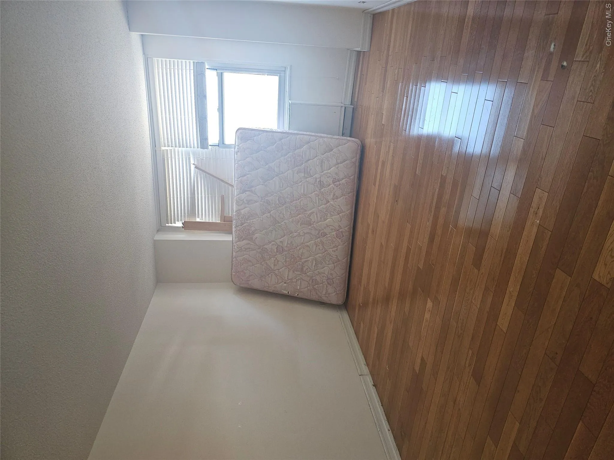Hardwood flooring throughout featuring baseboard trim and white painted walls Hardwood flooring throughout featuring baseboard trim and white painted walls