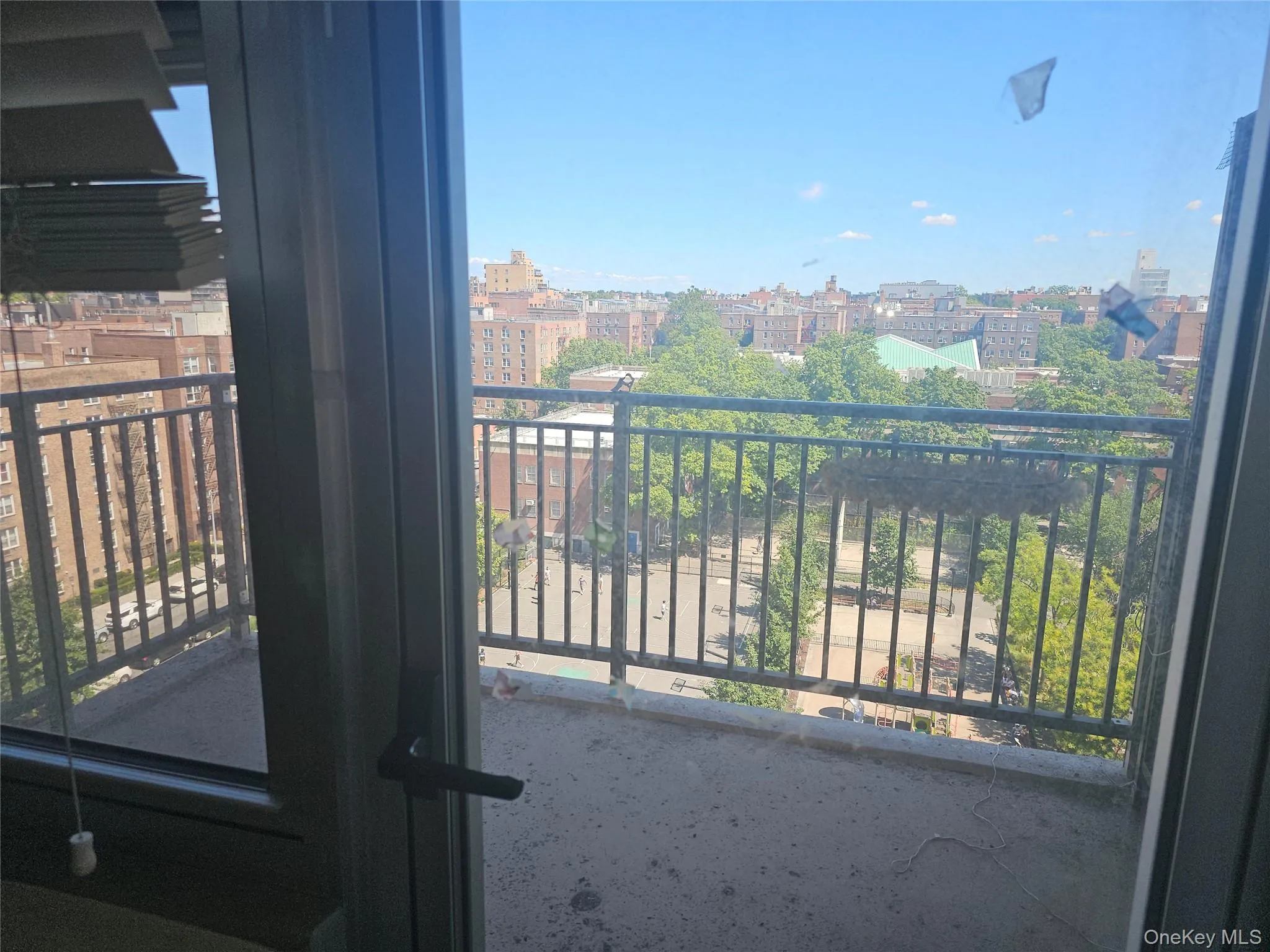Private balcony with metal railings and concrete flooring Private balcony with metal railings and concrete flooring