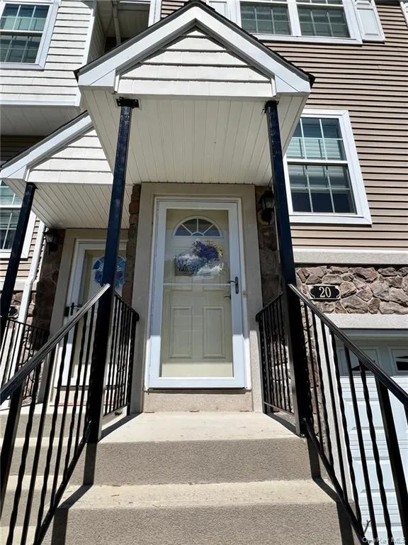 View of exterior entry featuring stone siding View of exterior entry featuring stone siding