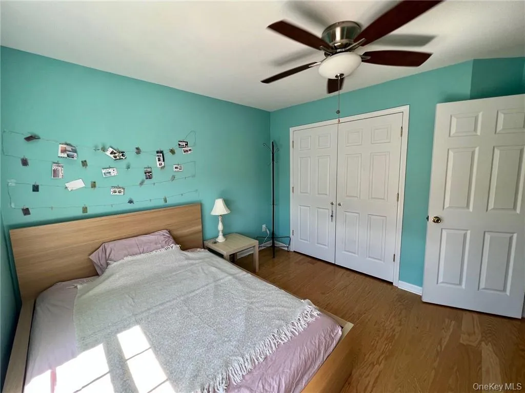 Bedroom #2 with a closet, wood finished floors, ceiling fan, and baseboards Bedroom #2 with a closet, wood finished floors, ceiling fan, and baseboards