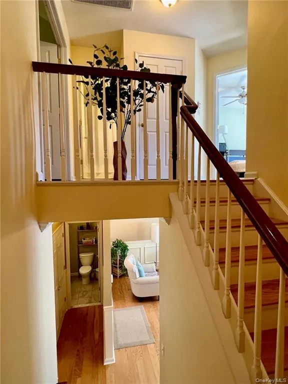 Staircase with wood finished floors and ceiling fan Staircase with wood finished floors and ceiling fan