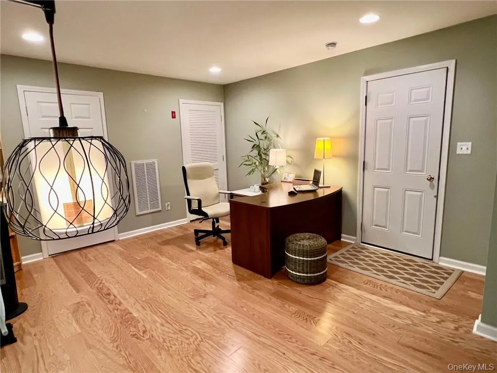 Home office in basement featuring wood finished floors, baseboards, and recessed lighting Home office in basement featuring wood finished floors, baseboards, and recessed lighting
