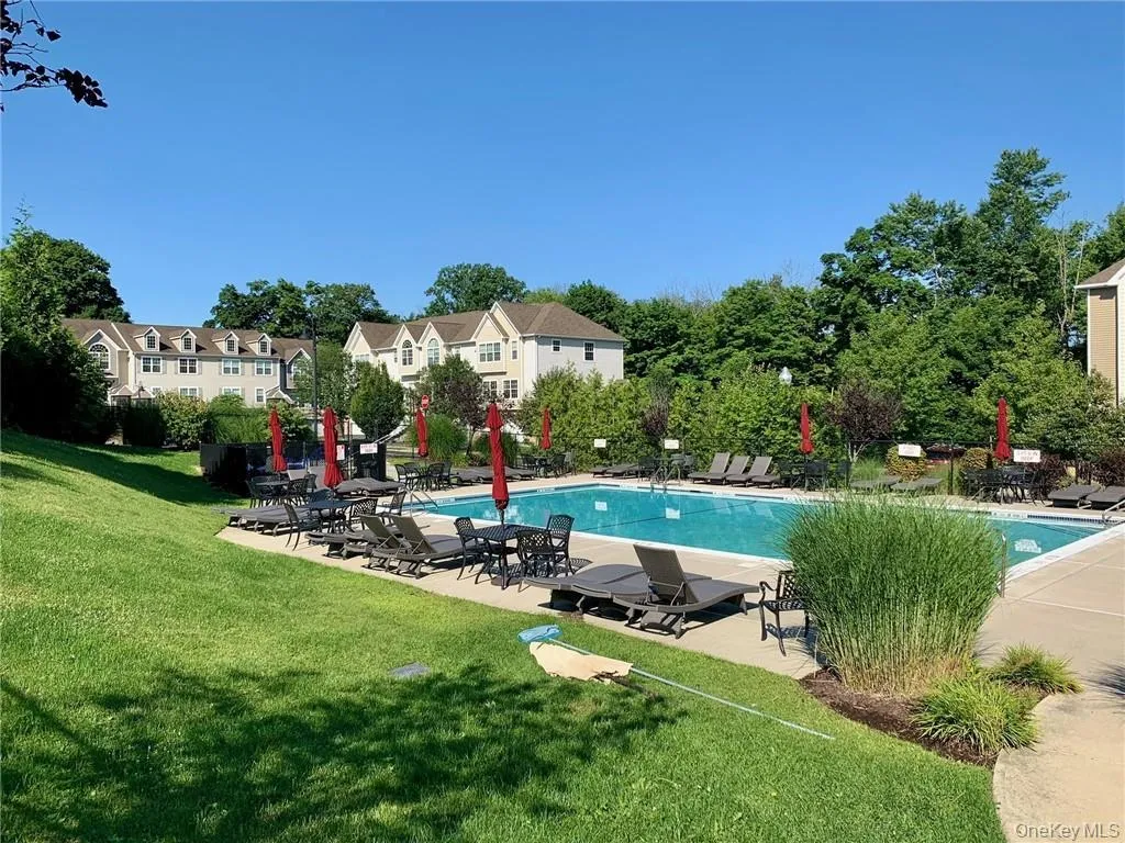 Community pool featuring a yard and a patio Community pool featuring a yard and a patio