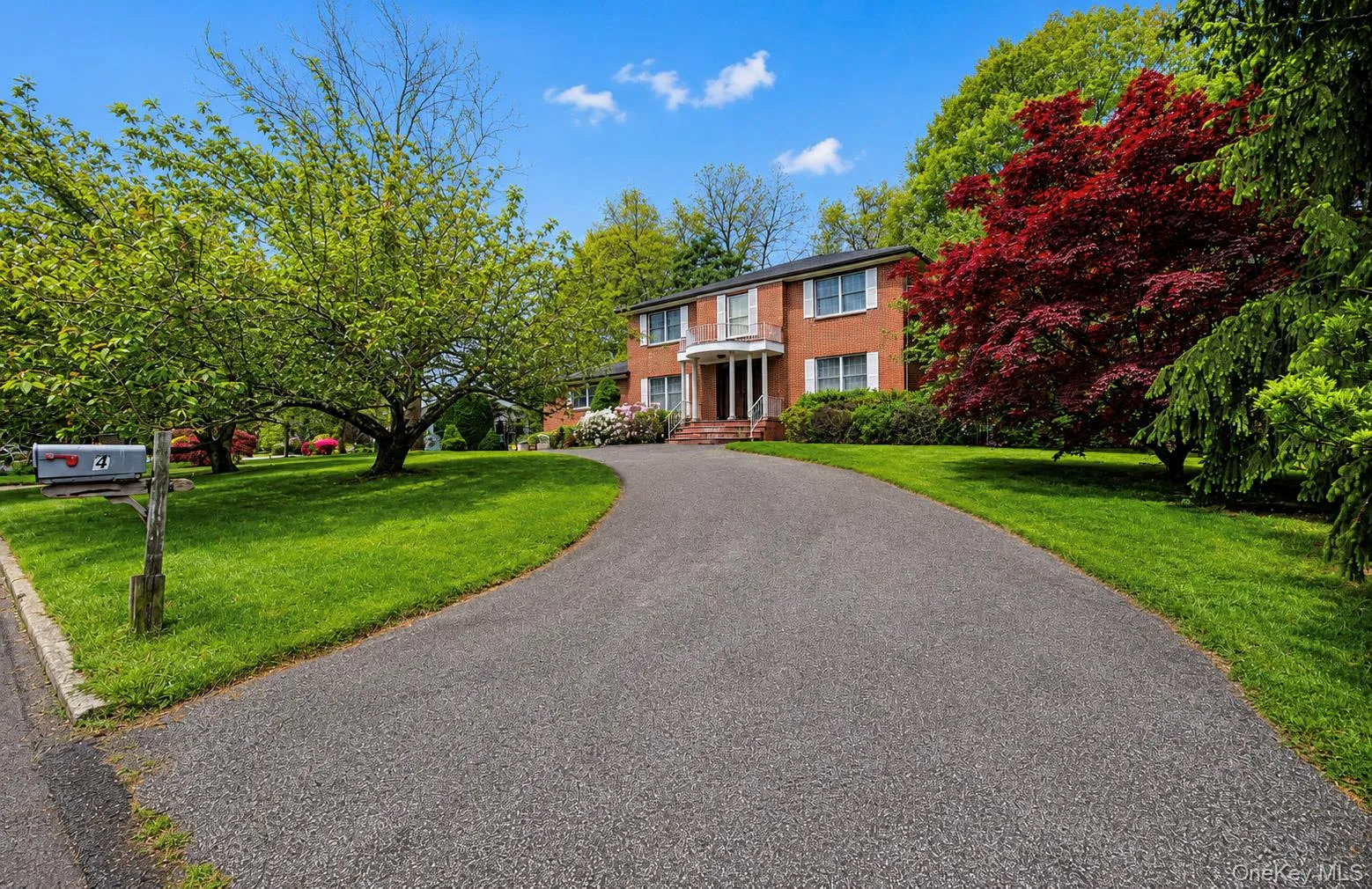 Brick exterior residence with a columned portico entry Brick exterior residence with a columned portico entry