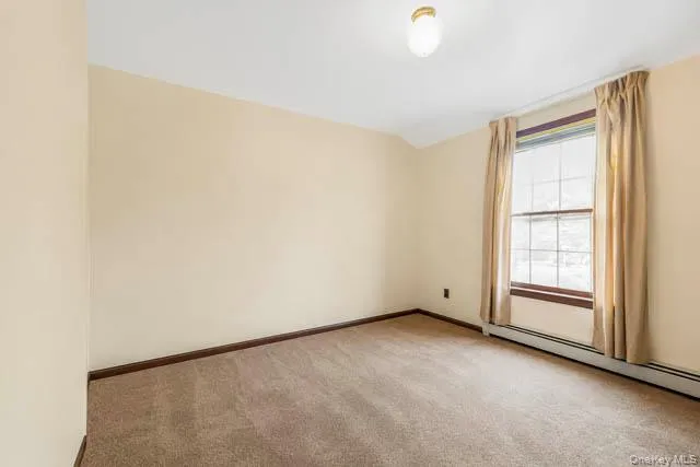 Neutral-toned carpeting enhances this space, complemented by beige wall paint and dark wood-finish baseboards Neutral-toned carpeting enhances this space, complemented by beige wall paint and dark wood-finish baseboards