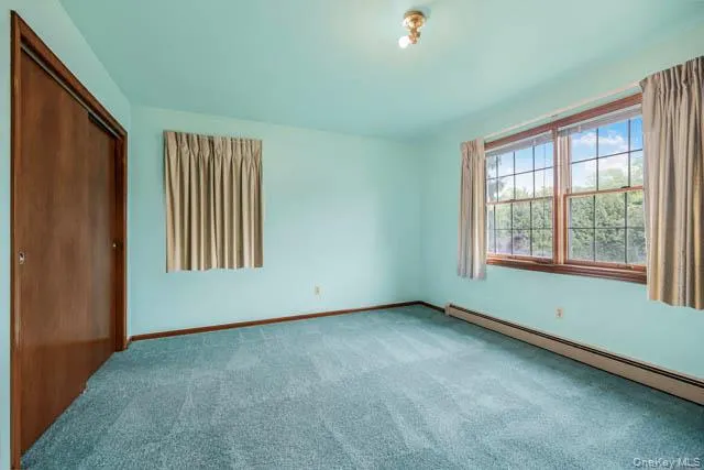 Light blue wall paint complements the teal-toned carpeting Light blue wall paint complements the teal-toned carpeting