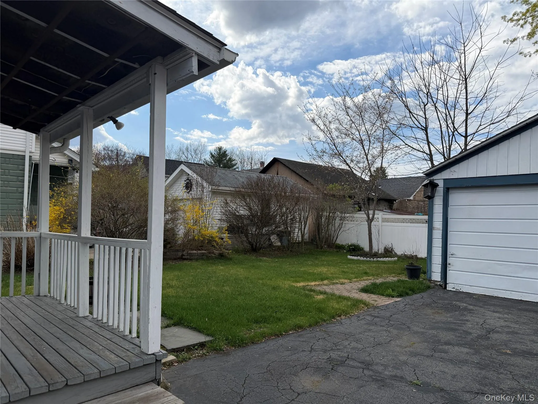 Back yard, covered porch and 2 car garage Back yard, covered porch and 2 car garage