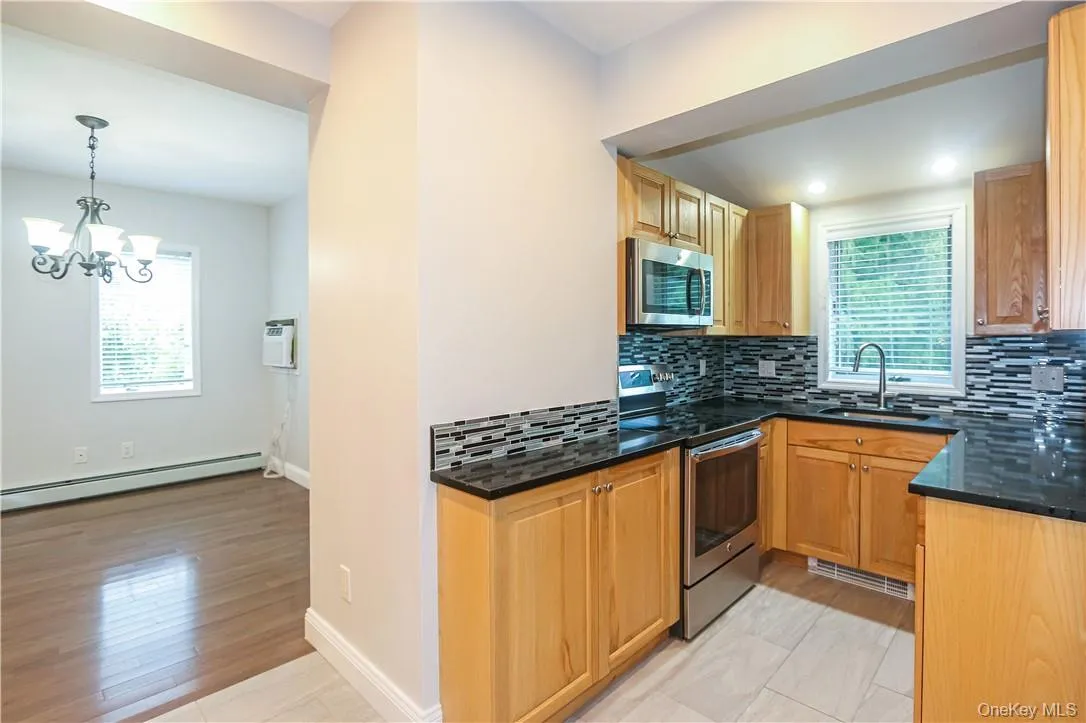 Kitchen features maple cabinets and granite counters. Kitchen features maple cabinets and granite counters.