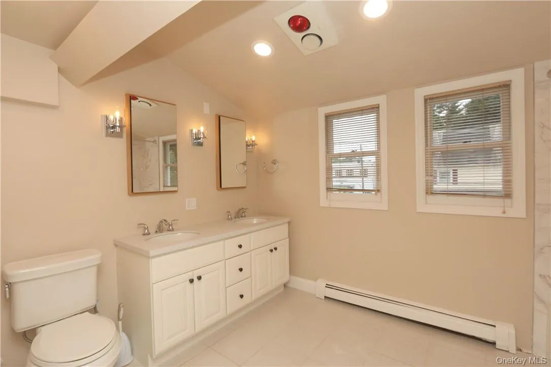 There is a large hall bathroom with ceramic flooring recessed lighting, a double vanity and tub. There is a large hall bathroom with ceramic flooring recessed lighting, a double vanity and tub.
