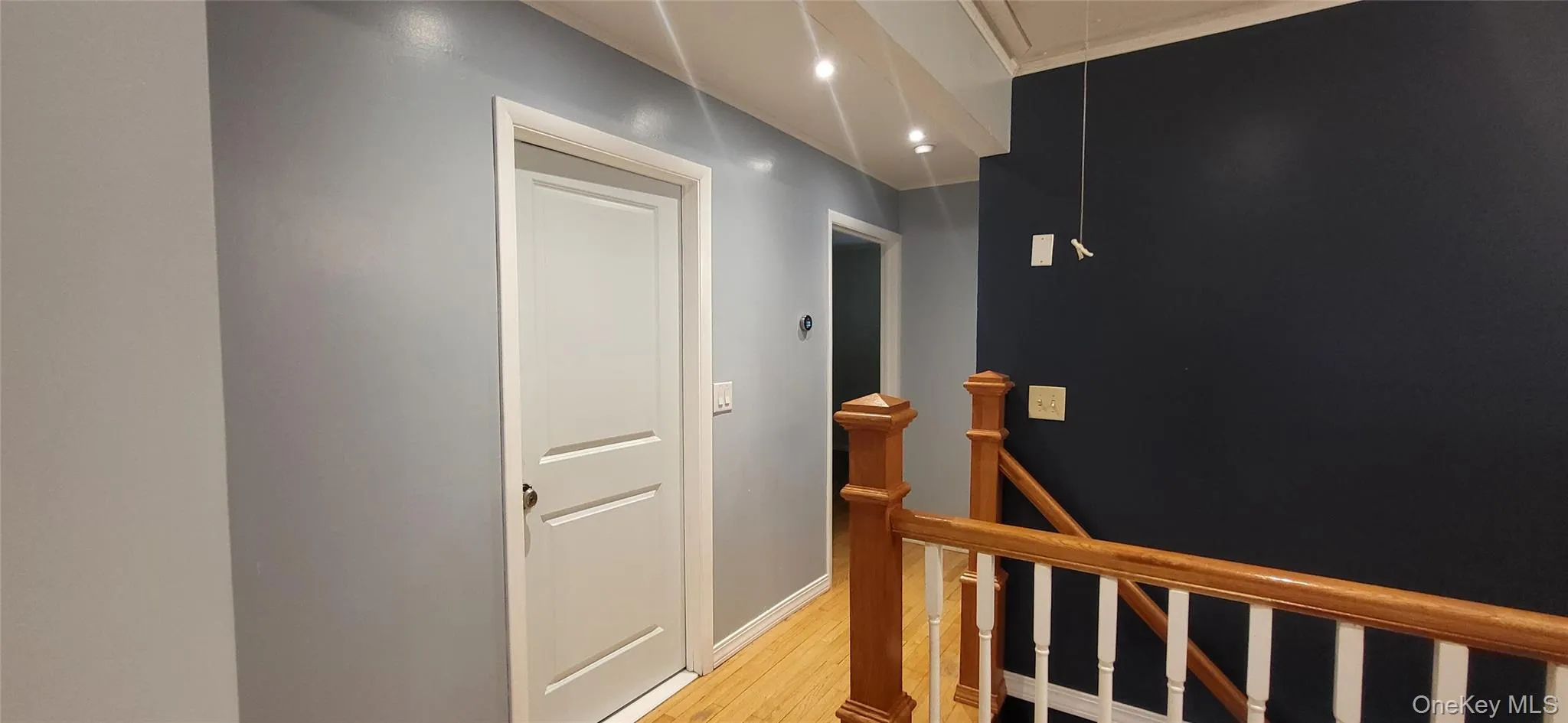 Hallway with stairs to basement Hallway with stairs to basement
