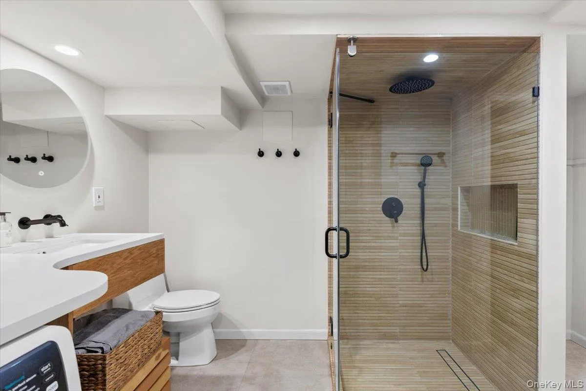 Modern laundry room and full bath. Modern laundry room and full bath.