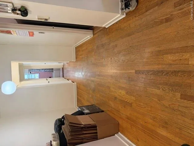 Hardwood flooring extends throughout this interior space, featuring a neutral color palette Hardwood flooring extends throughout this interior space, featuring a neutral color palette