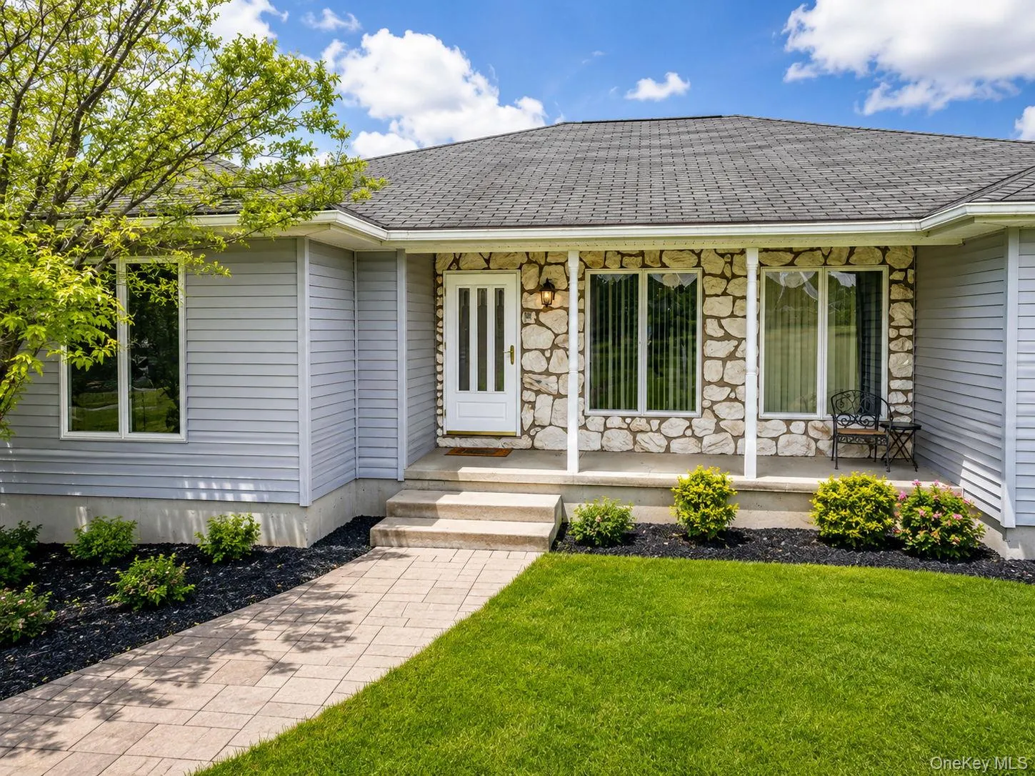 Stone and siding exterior with a dark shingle roof Stone and siding exterior with a dark shingle roof