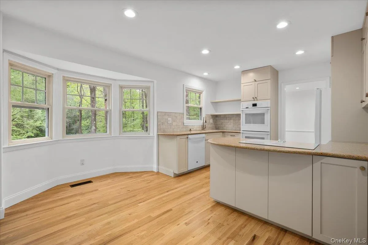 Eat-in kitchen with bay windows. Eat-in kitchen with bay windows.