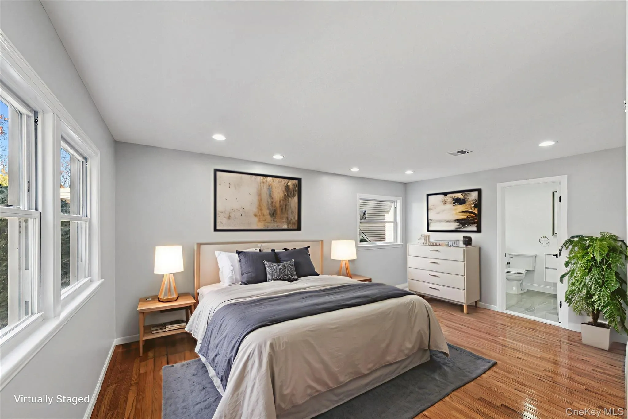 First Floor Primary Bedroom with wood-finish flooring, recessed lighting, and en-suite First Floor Primary Bedroom with wood-finish flooring, recessed lighting, and en-suite