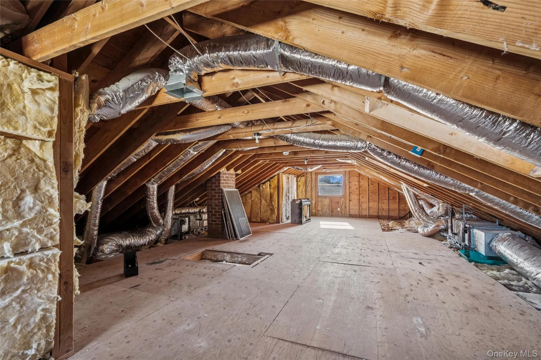 Spacious attic area offering storage and plywood flooring, and HVAC ductwork Spacious attic area offering storage and plywood flooring, and HVAC ductwork