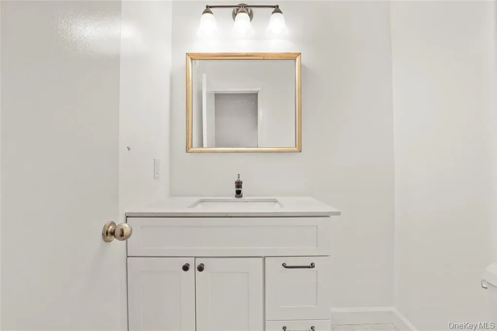 Bathroom with vanity, toilet, and baseboards Bathroom with vanity, toilet, and baseboards