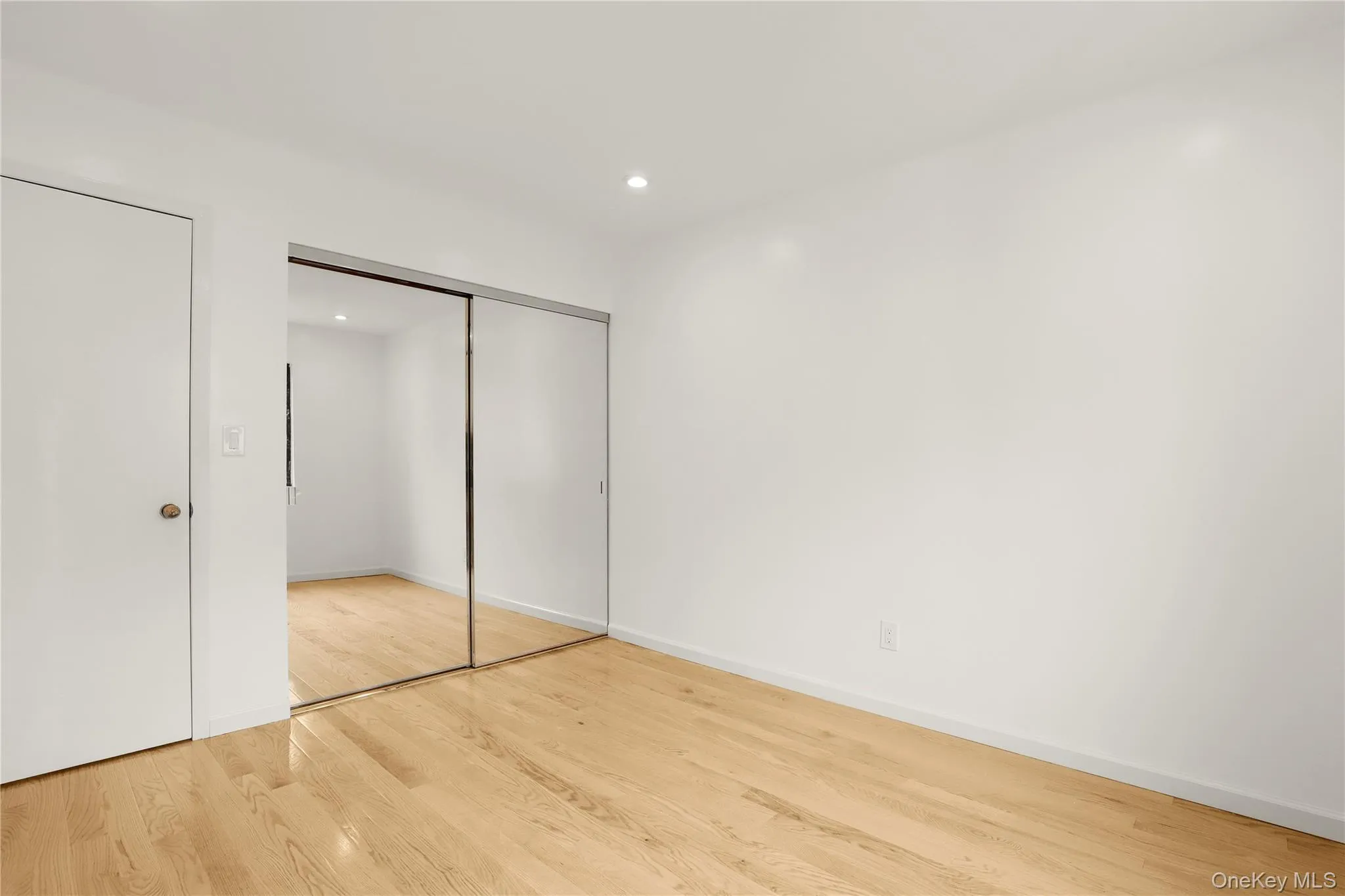 Unfurnished bedroom featuring wood finished floors, a closet, baseboards, and recessed lighting Unfurnished bedroom featuring wood finished floors, a closet, baseboards, and recessed lighting