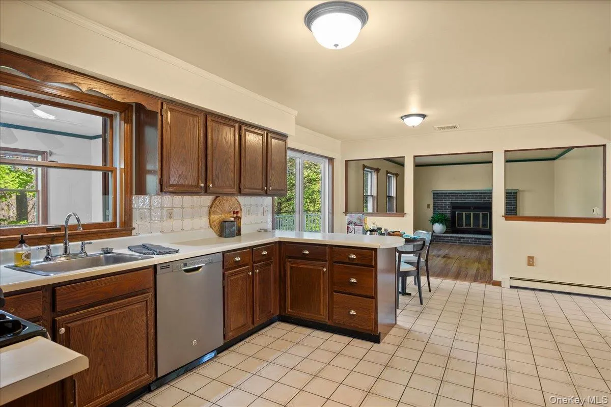The open kitchen-family room layout is great for watching the kids, watching a game, or lounging by the home's fireplace. The open kitchen-family room layout is great for watching the kids, watching a game, or lounging by the home's fireplace.