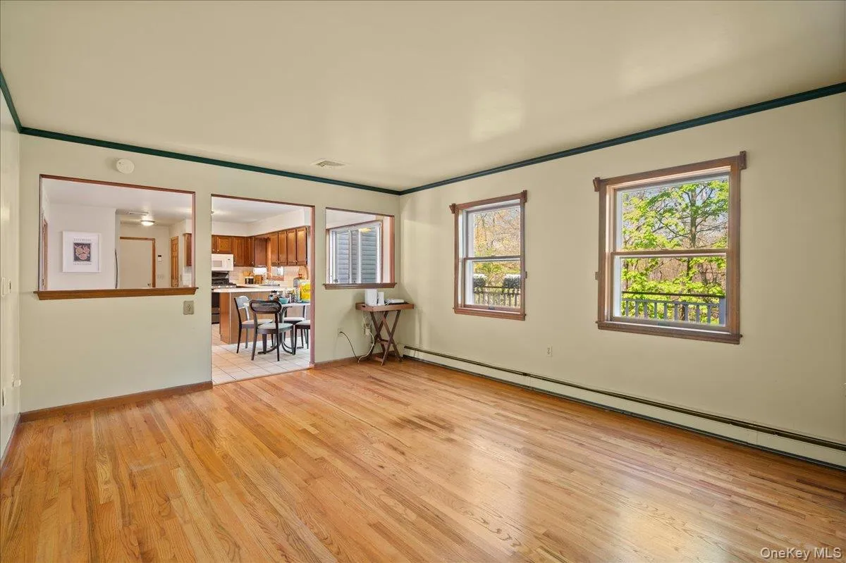 This family room has interior views of the kitchen and exterior views of the deck and wooded back yard. This family room has interior views of the kitchen and exterior views of the deck and wooded back yard.