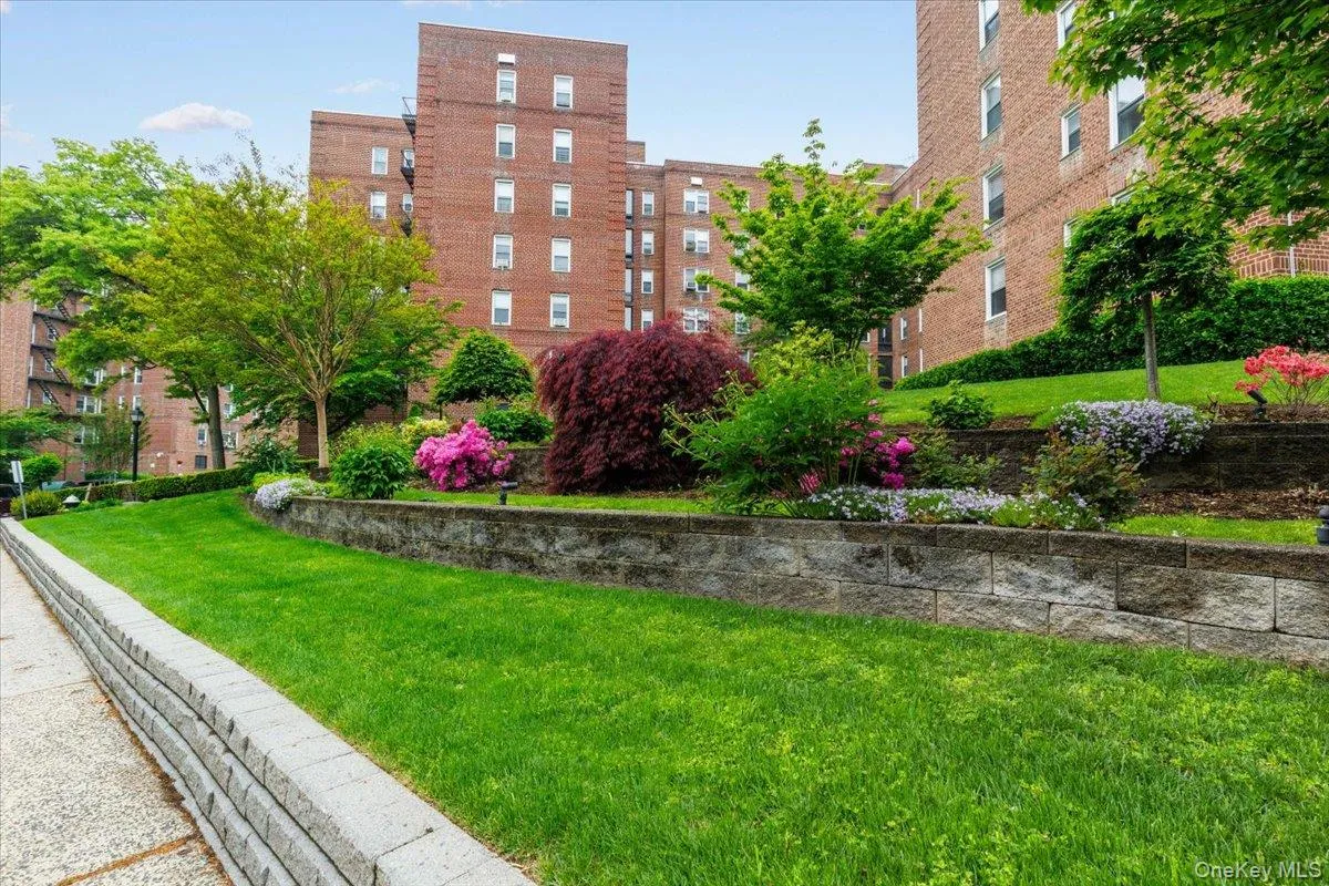 Manicured grounds featuring vibrant landscaping with diverse plantings and flowering shrubs Manicured grounds featuring vibrant landscaping with diverse plantings and flowering shrubs