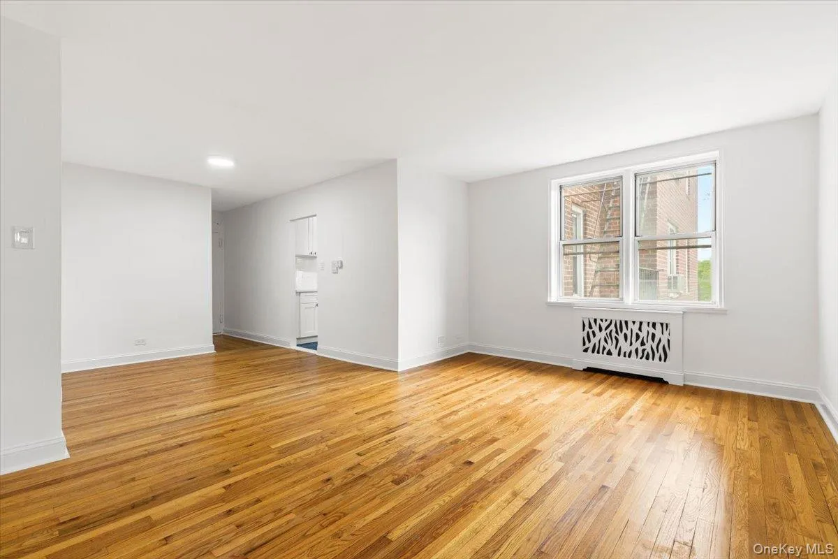 Bright interior with wood-finish flooring and white baseboards Bright interior with wood-finish flooring and white baseboards