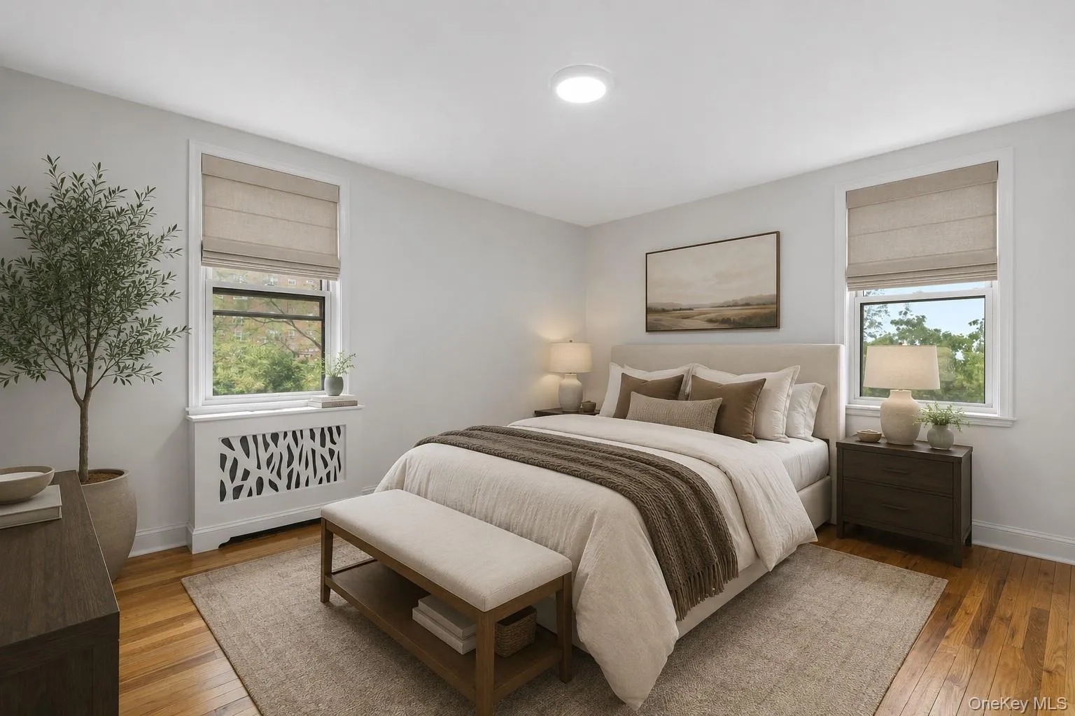 Virtually Staged - Bright interior bedroom featuring light wall paint, wood-finish flooring, and two windows with natural light Virtually Staged - Bright interior bedroom featuring light wall paint, wood-finish flooring, and two windows with natural light
