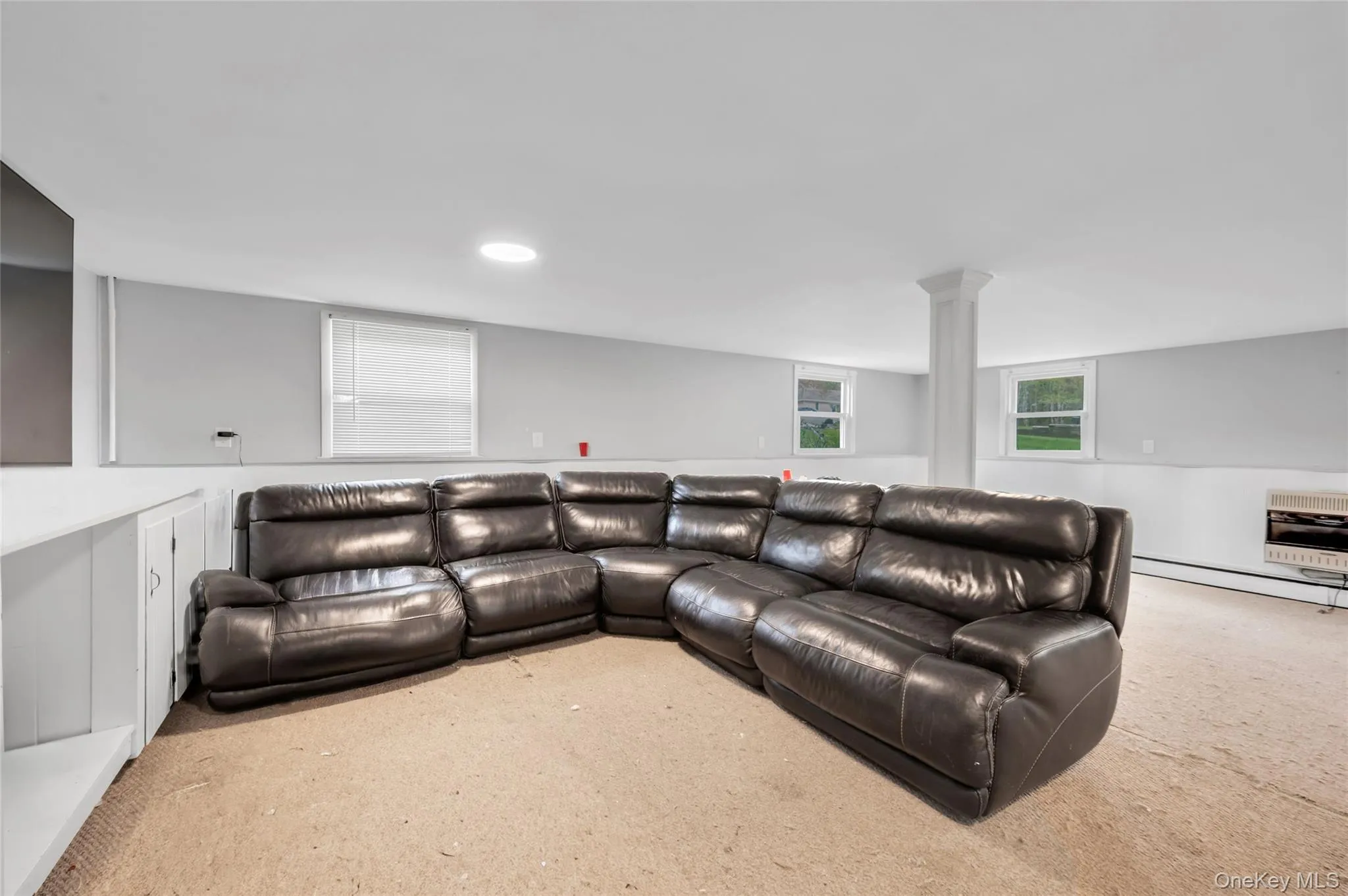 Spacious room with light gray walls, white wainscoting, and recessed lighting Spacious room with light gray walls, white wainscoting, and recessed lighting