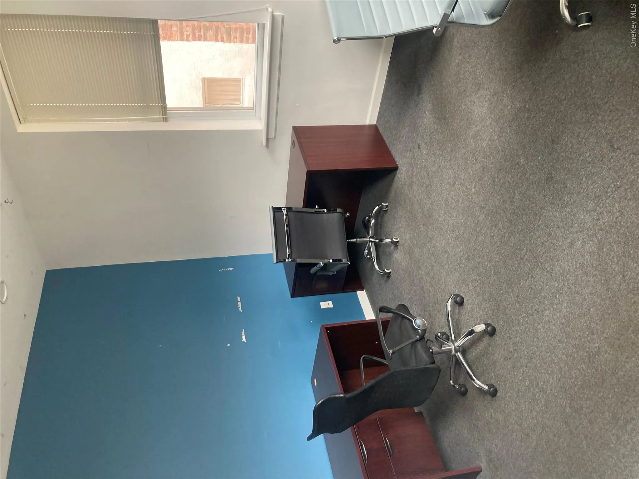 Office space featuring carpet flooring and multiple windows with blinds Office space featuring carpet flooring and multiple windows with blinds